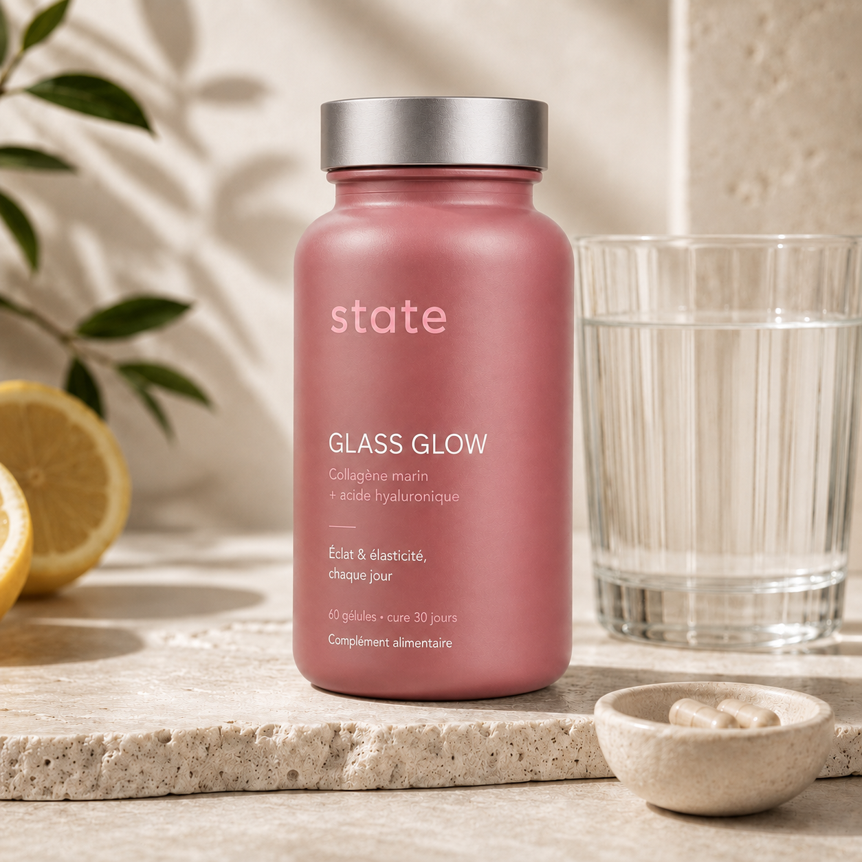 Glass Glow by state on travertine with lemon and a glass of water